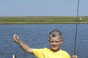 A young angler holds his latest catch