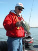 An angler holds a crappie