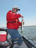 An angler holds a walleye